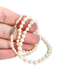 This is a stunning example of a classic Japanese akoya saltwater cultured pearl necklace.  The pearls are graduated and range from 3.00-7.00mm. They are round with excellent luster and sharp rosy overtones. The have almost no blemishes.  Clasp is in solid yellow gold and is a filigree design. It is stamped "14K".  Total length is 17.50 inches.  All pearls are truly vintage and have only been lightly cleaned and restrung.